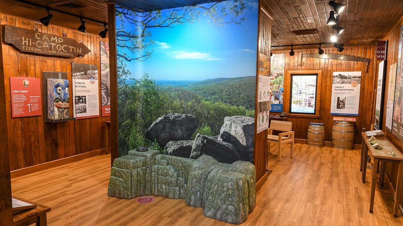 A large room with multiple history and nature exhibits with a central overlook display.