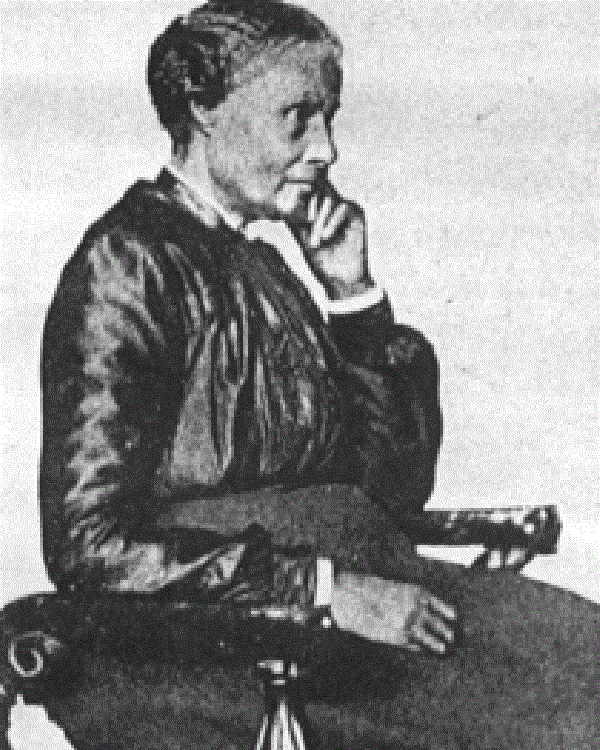 Historic image of a black woman sitting in chair.