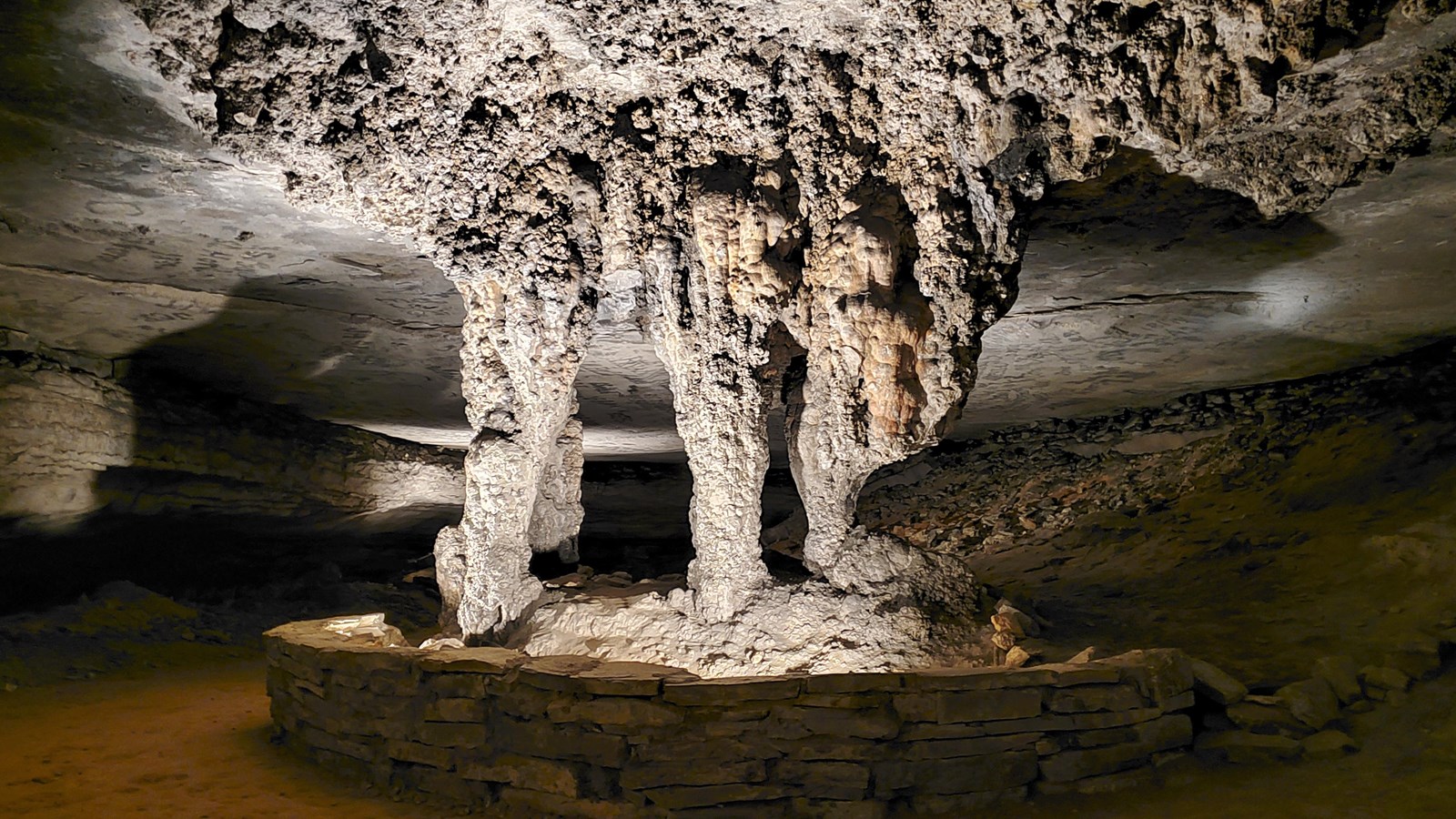 A series of dramatic looking stone columns in a cave passage. 