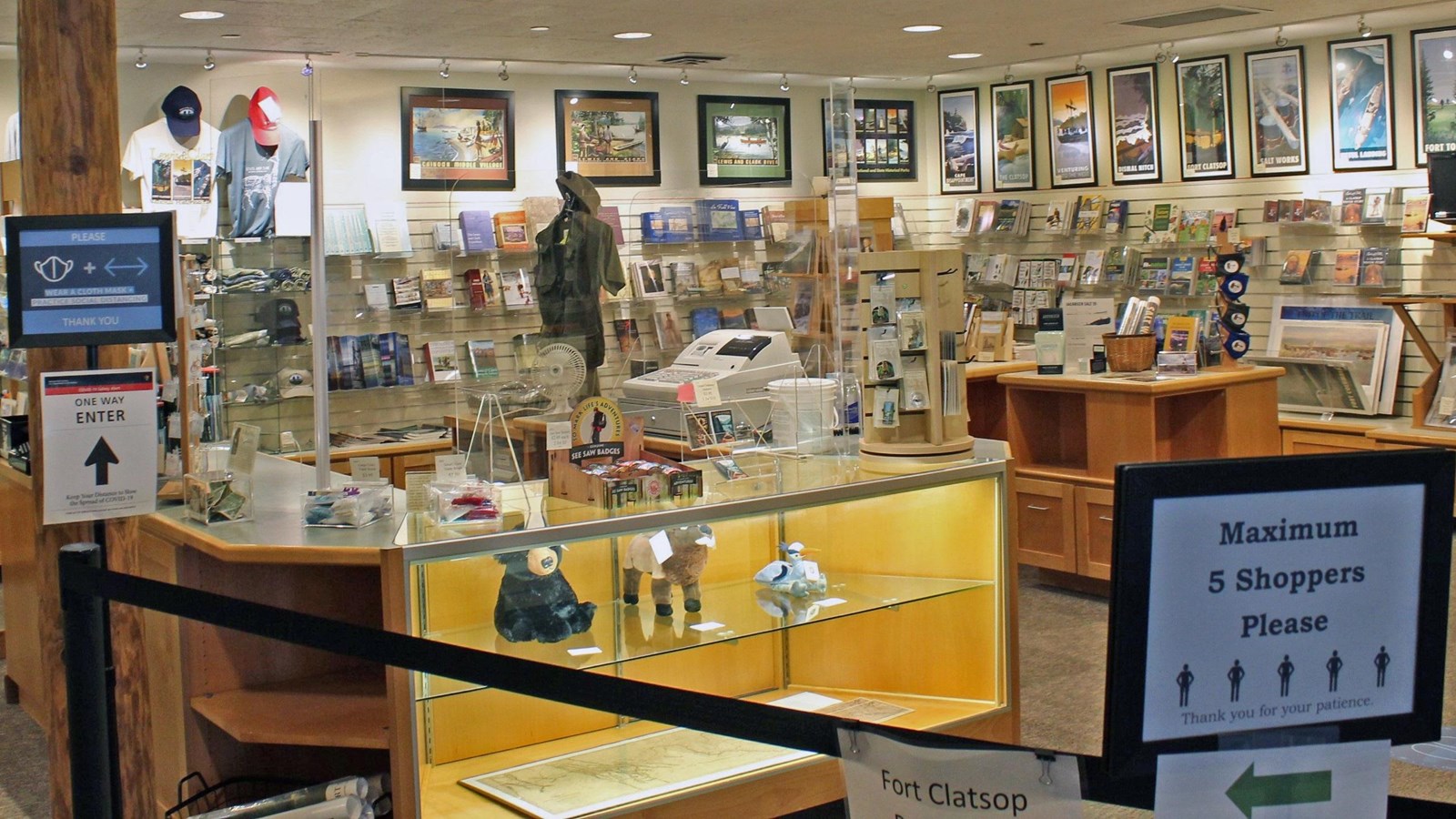 Book lined shelves with posters of different L&C sites line the walls, signs warning visitors ahead.