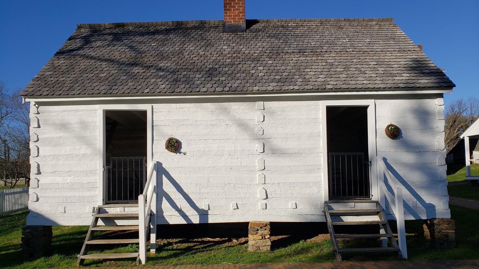 A small white building with two front doors on each end.