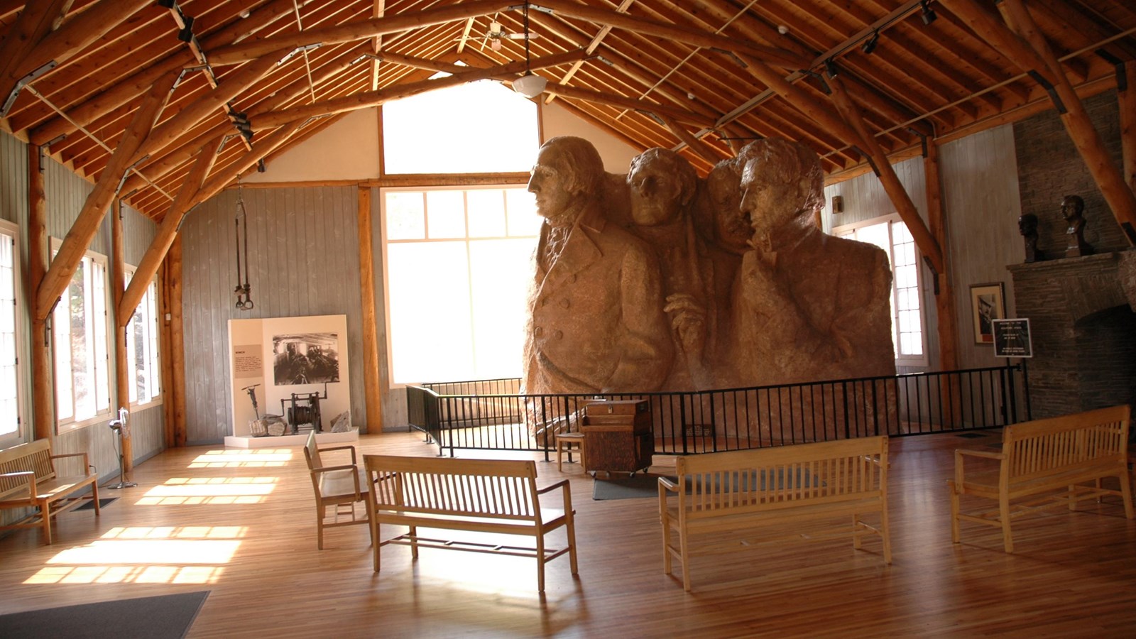 Photo of interior of Sculptor\'s Studio with the scale model to the right and pine log beams overhead
