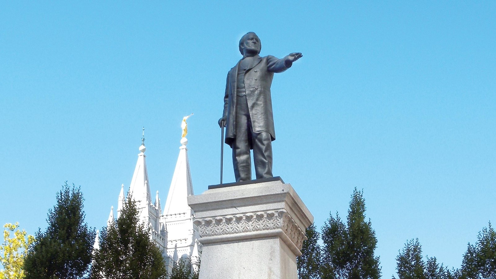 A large iron statue of a man pointing. 