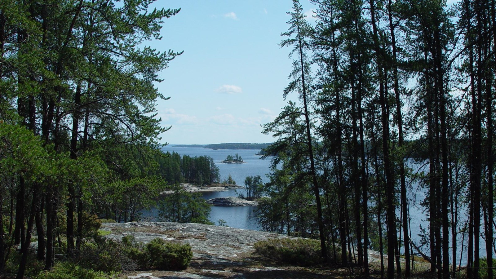 A view from a rocky out cropping of a lake with islands scattered throughout.