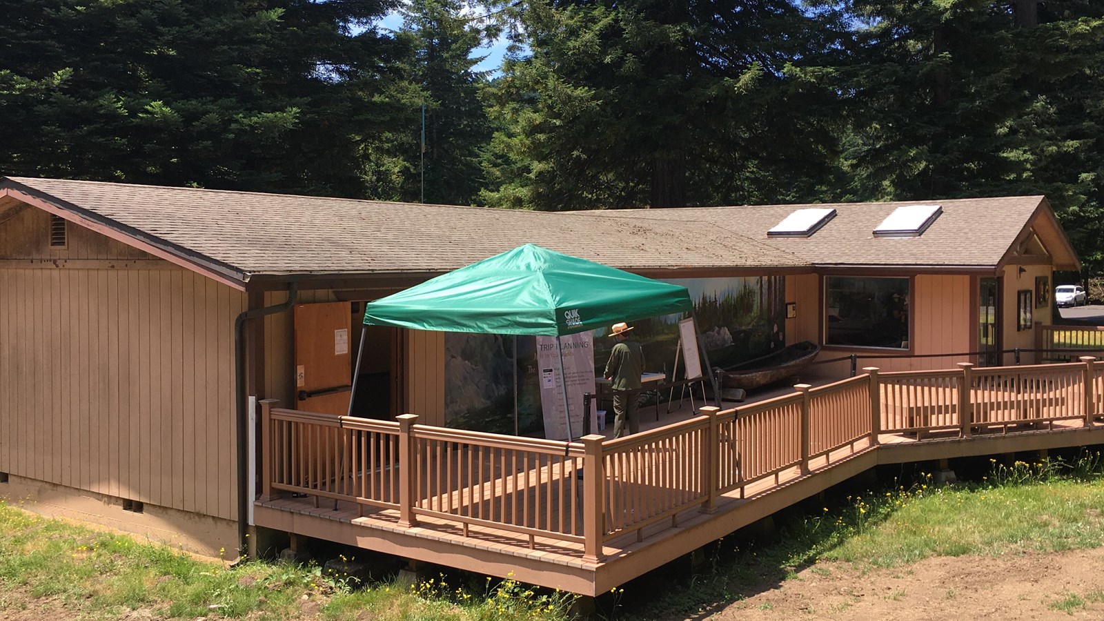 A brown building set next to large trees.