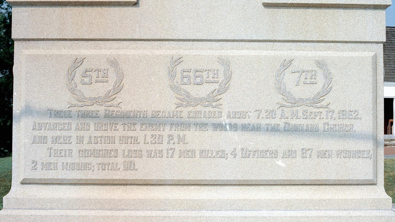 Text on a stone tablet, the largest text says, 5th, 66th, and 7th. 