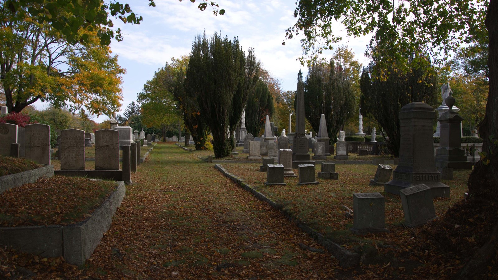 Grassy walking-path in western cemetery between burial plots