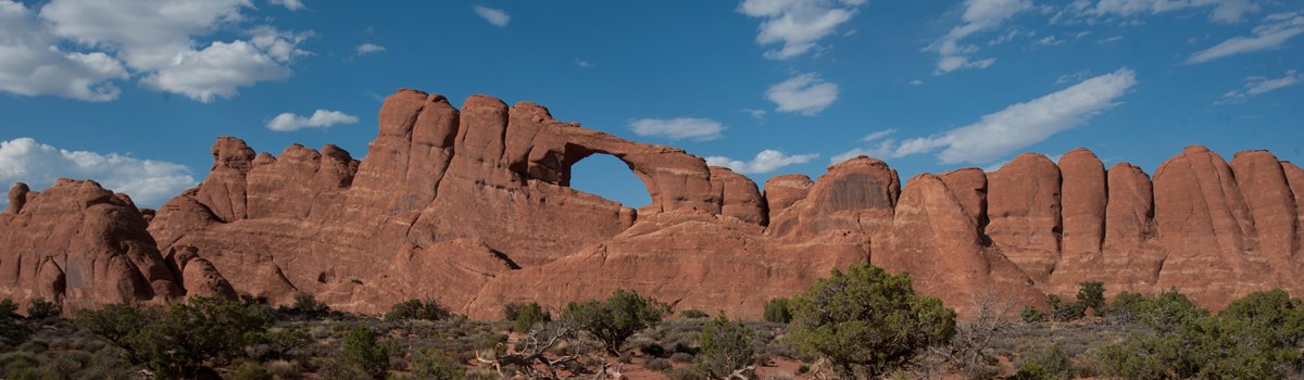 an arch in a high rock wall
