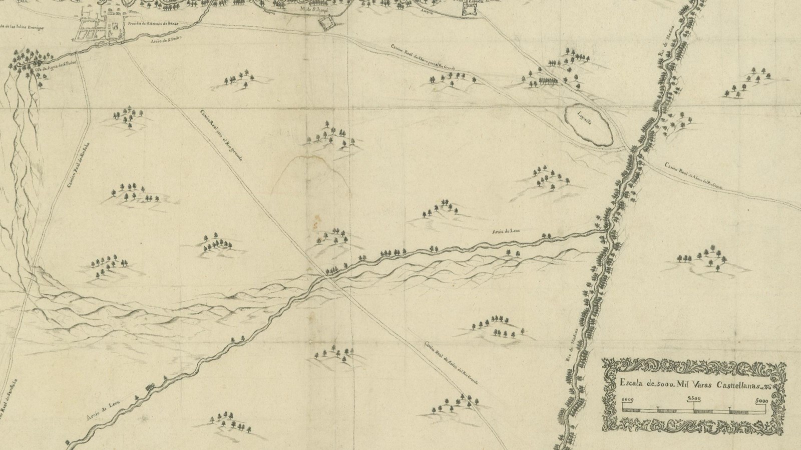 A photo of a time-worn map written in Spanish, depicting a river through mostly rolling hills.
