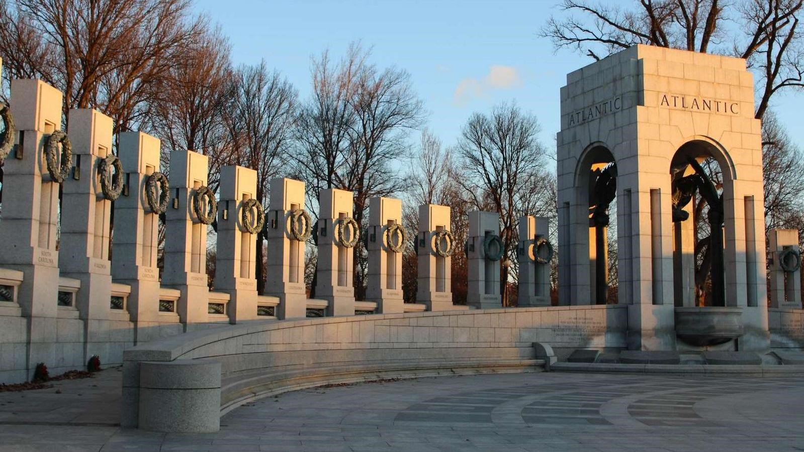Line of stone state pillars and walkway leading to the stone Atlantic archway