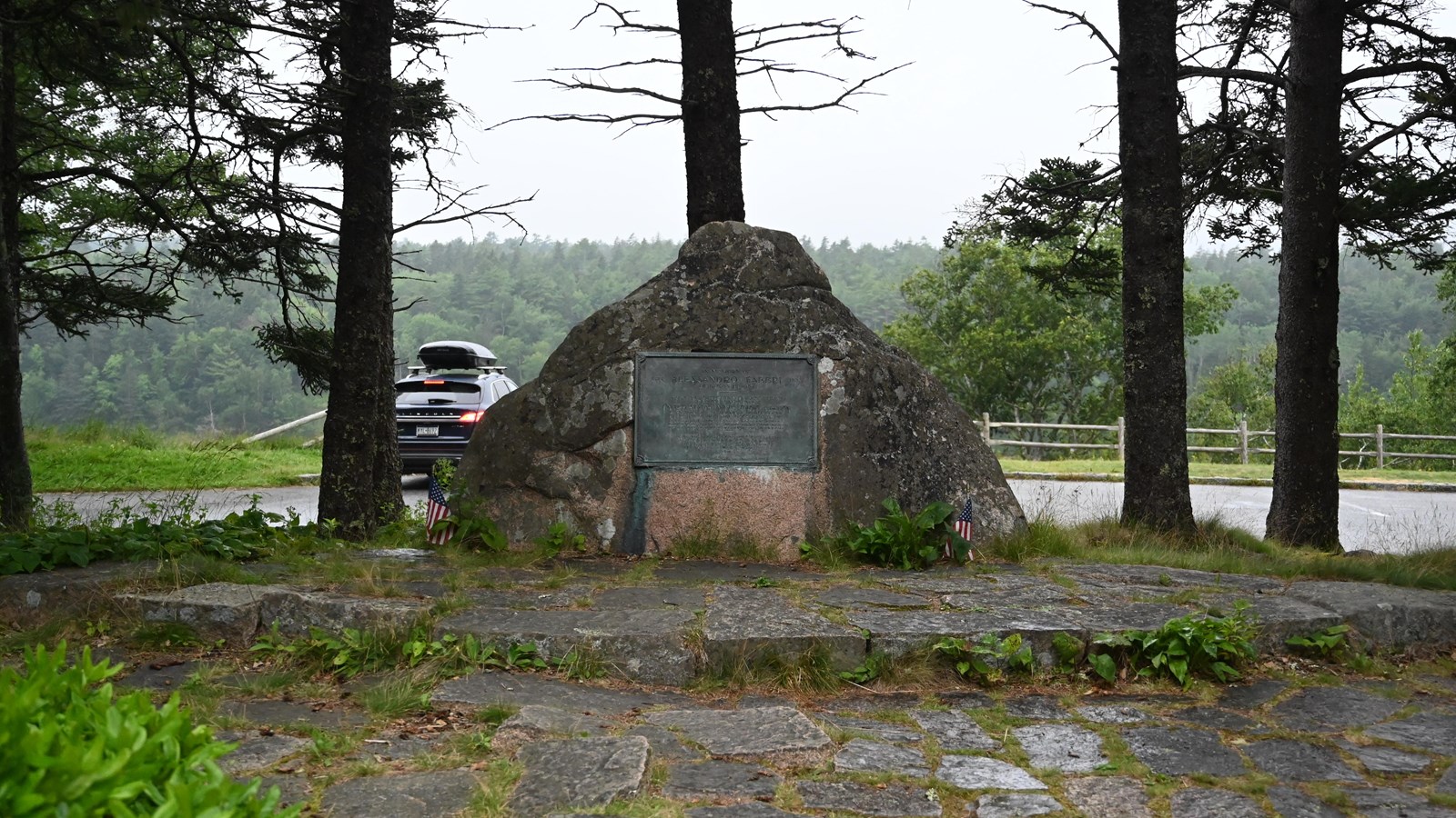 Large pointed rock with plaque on the middle