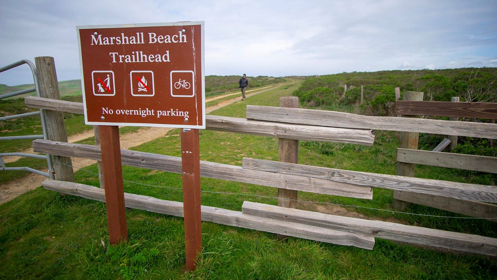 A park sign with: Marshall Beach Trailhead, no pets, no fires. Bikes are allowed.