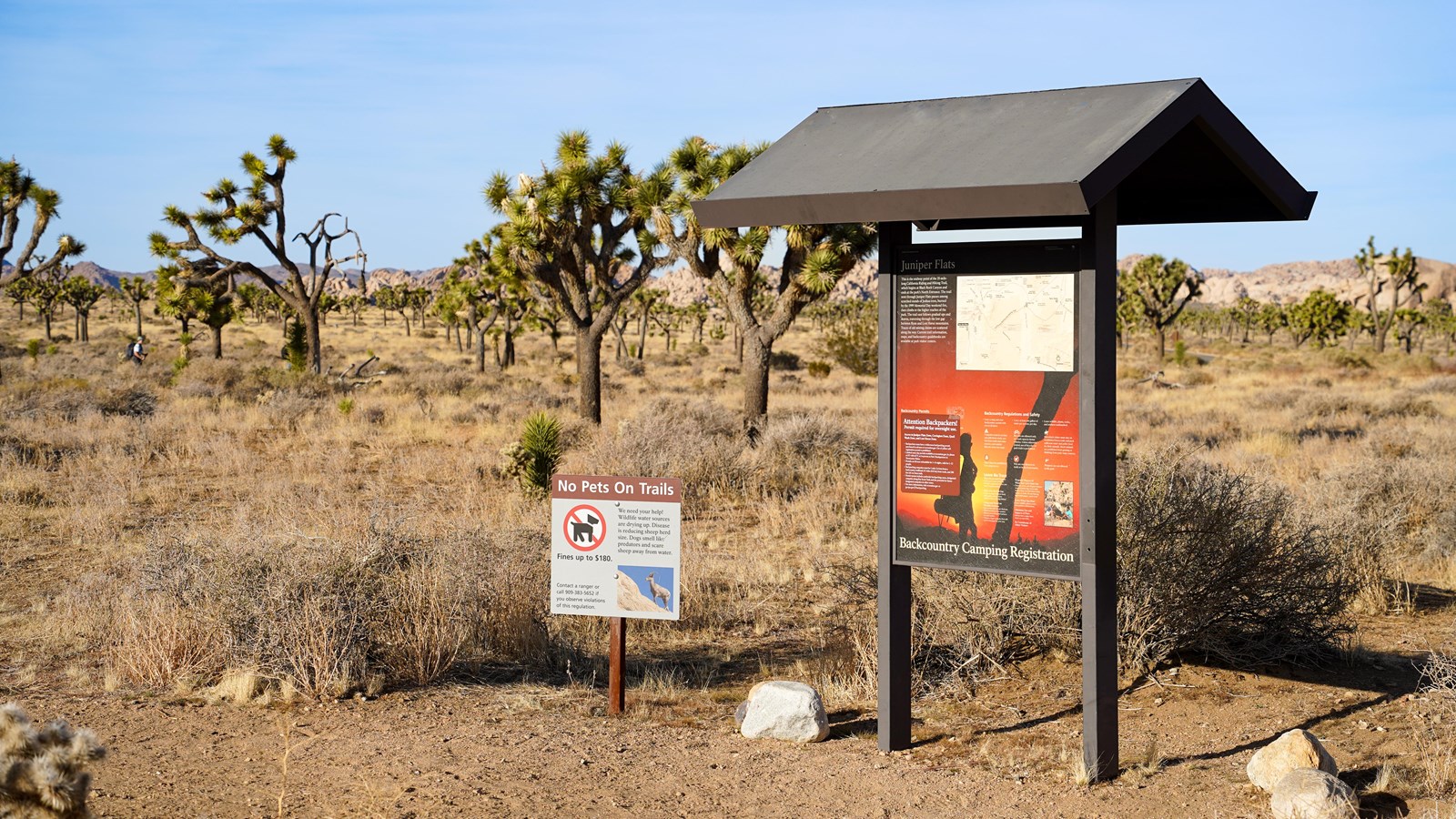 A trailhead sign reads