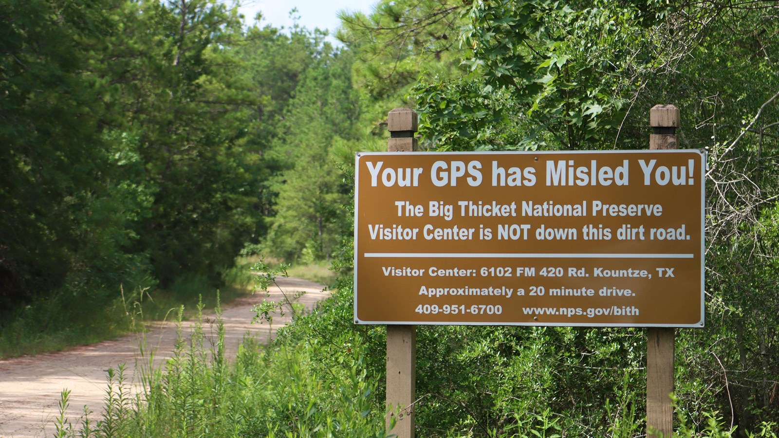 A brown sign with text that reads