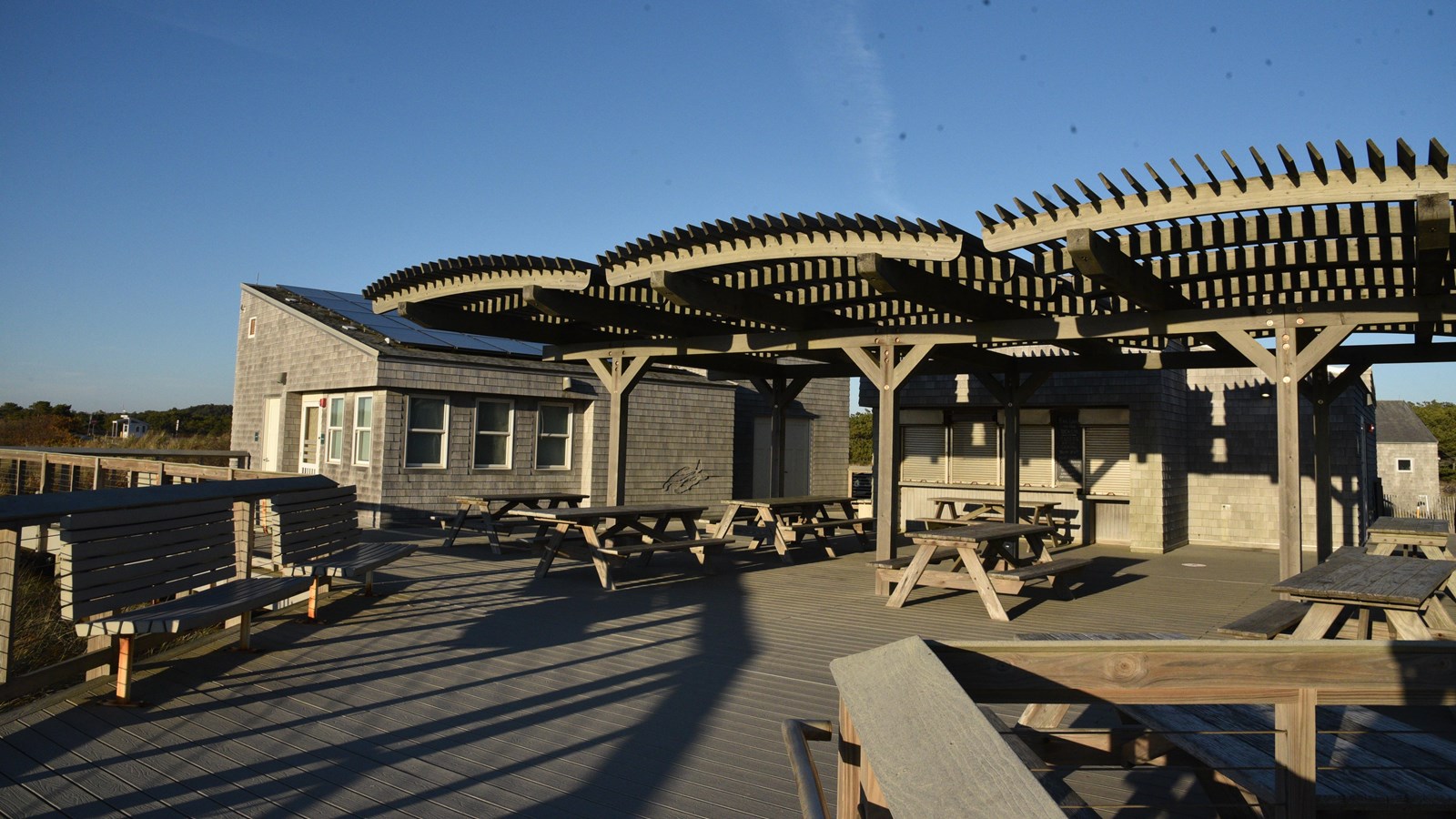 Snack bar area with picnic table seating and an awning.