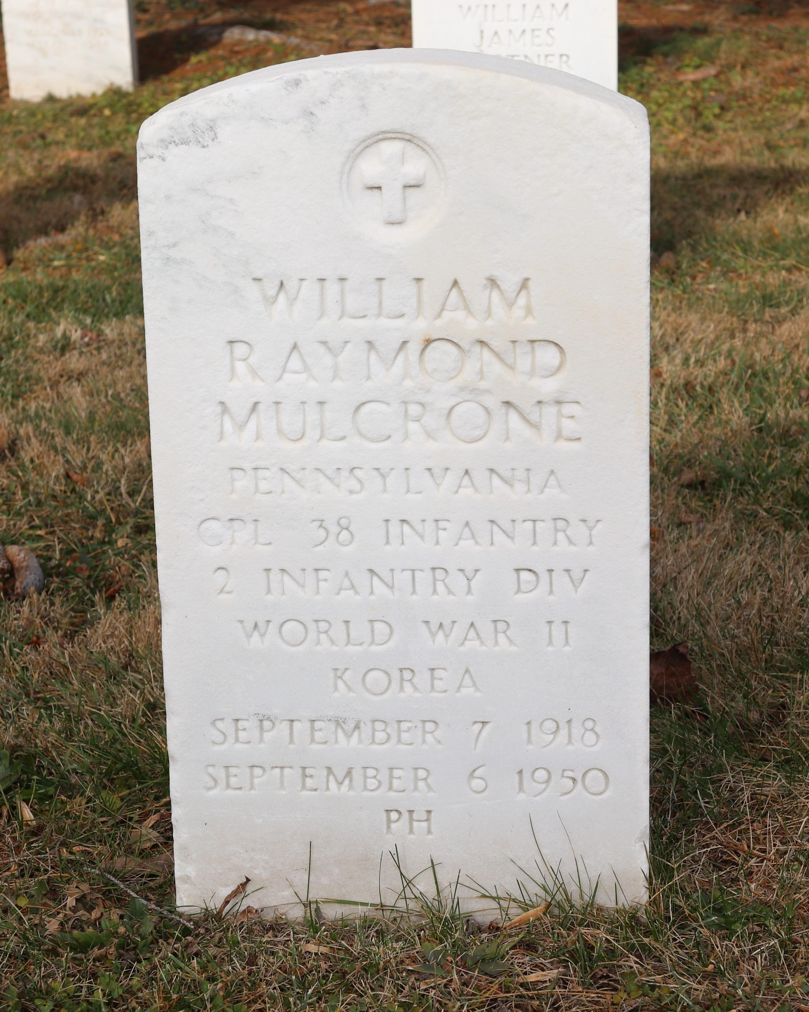 A white marble headstone for Cpl. William R. Mulcrone