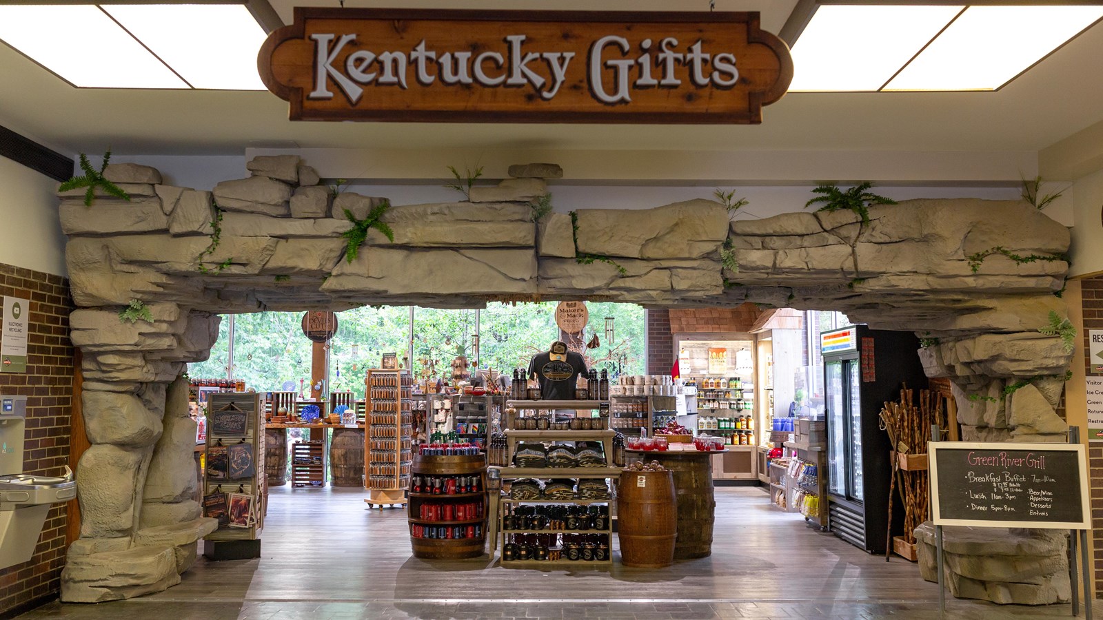 A rock facade arch frames the Kentucky Gifts giftshop\'s aisles of souvenirs.