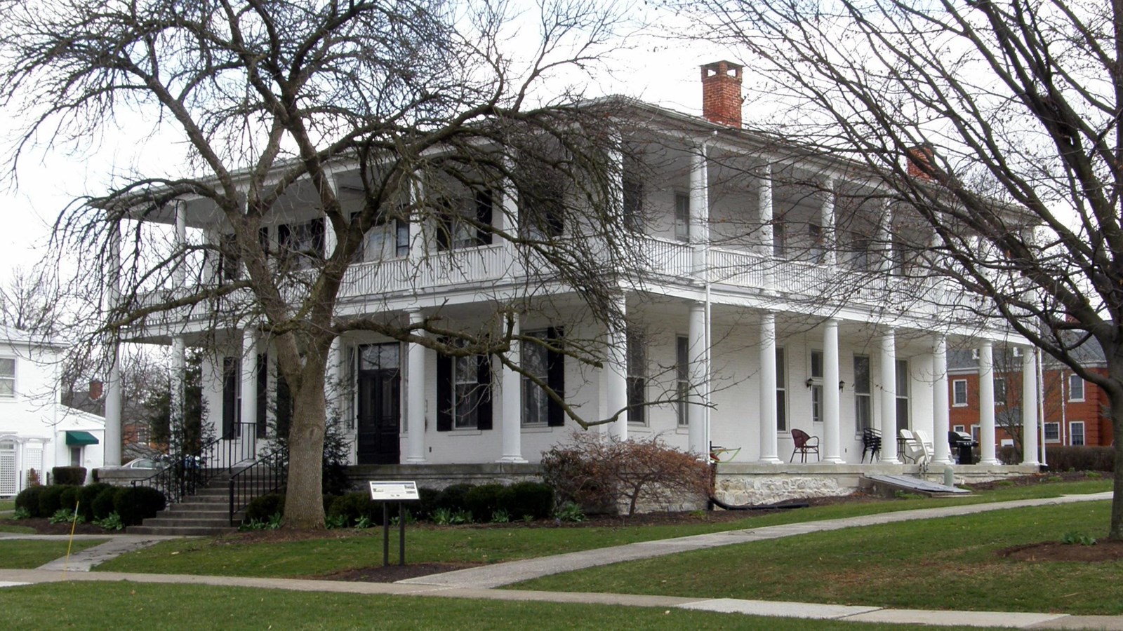 A white two-story square building with columns.