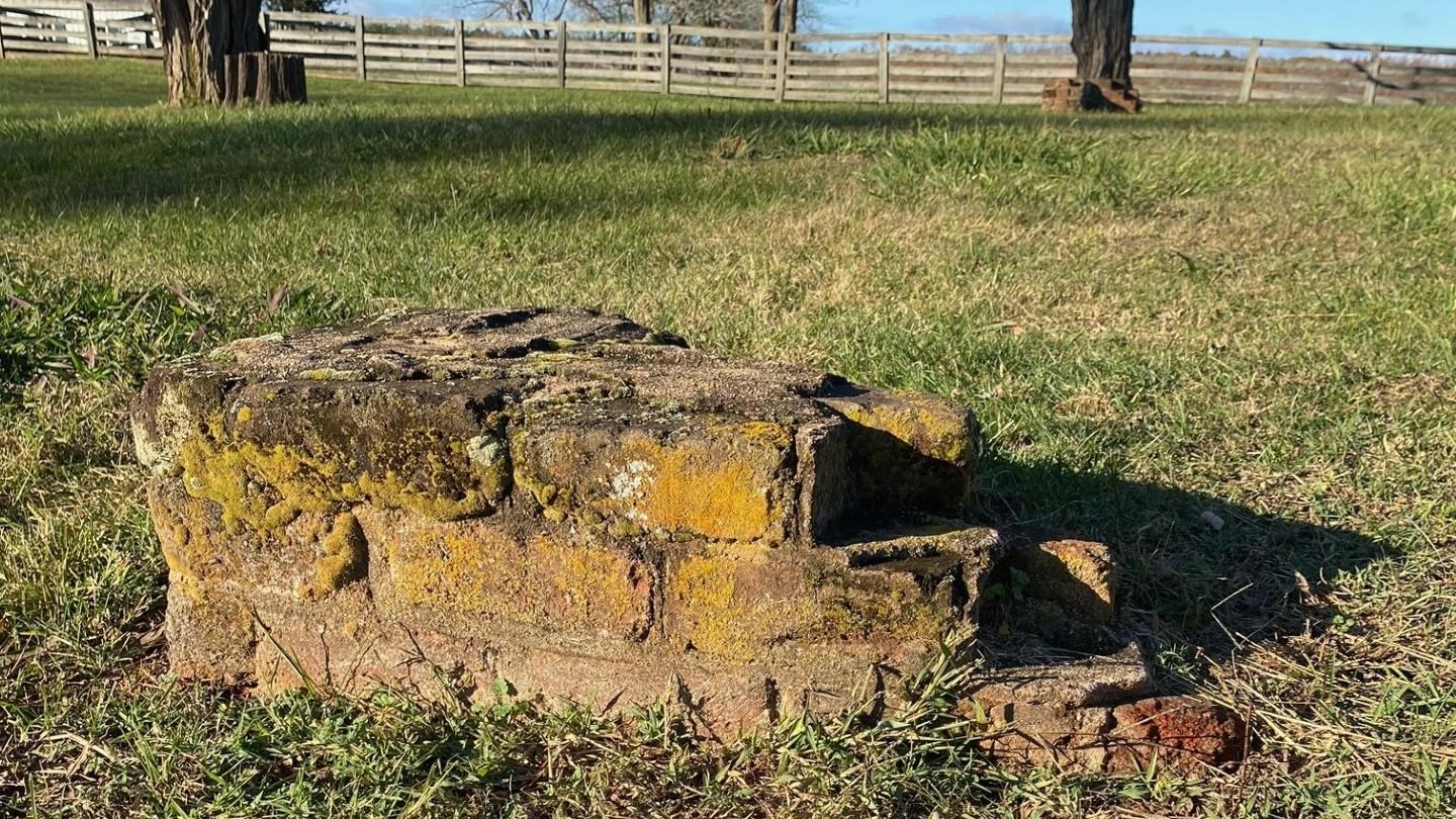 A brick pillar is all that remains at the old jail site