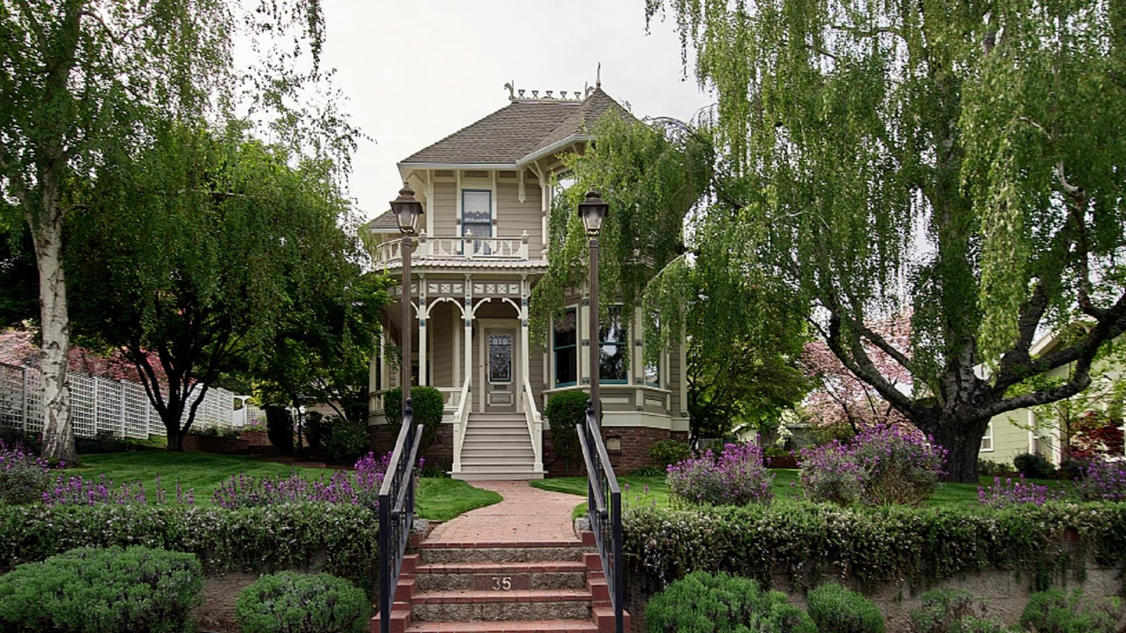 House on a hill with elaborate wrap-around porch.