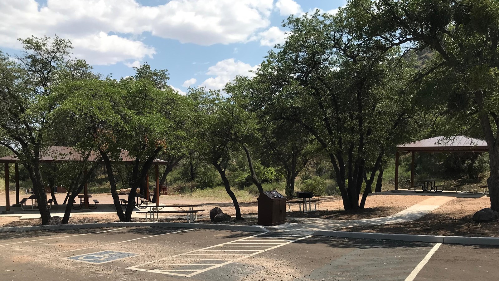 Accessible picnic ramadas nestled in the trees.