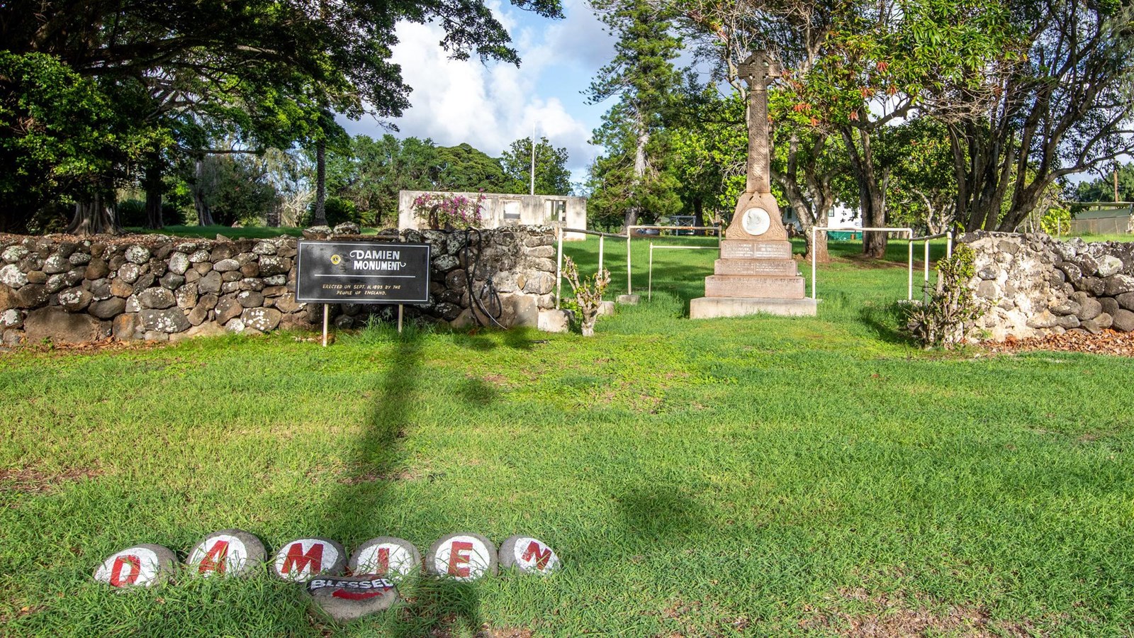 A series of painted rocks that spell out the name DAMIEN and a rock with the word Blessed. 