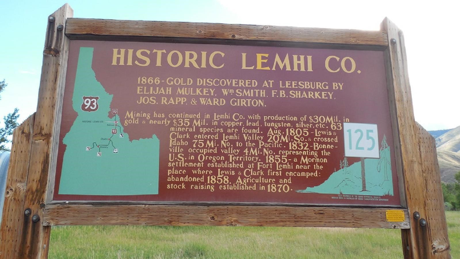 A brown historical marker sign showing a map and important dates for Lemhi County