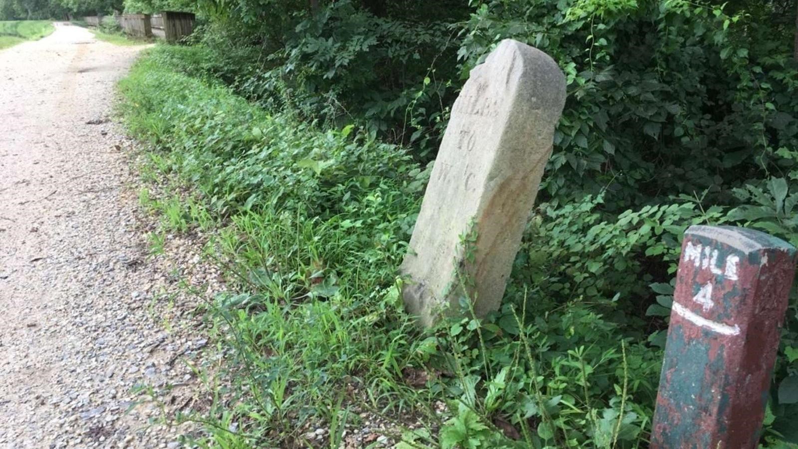 A mile marker sits next to the towpath and marks the forth mile of the C&O Canal