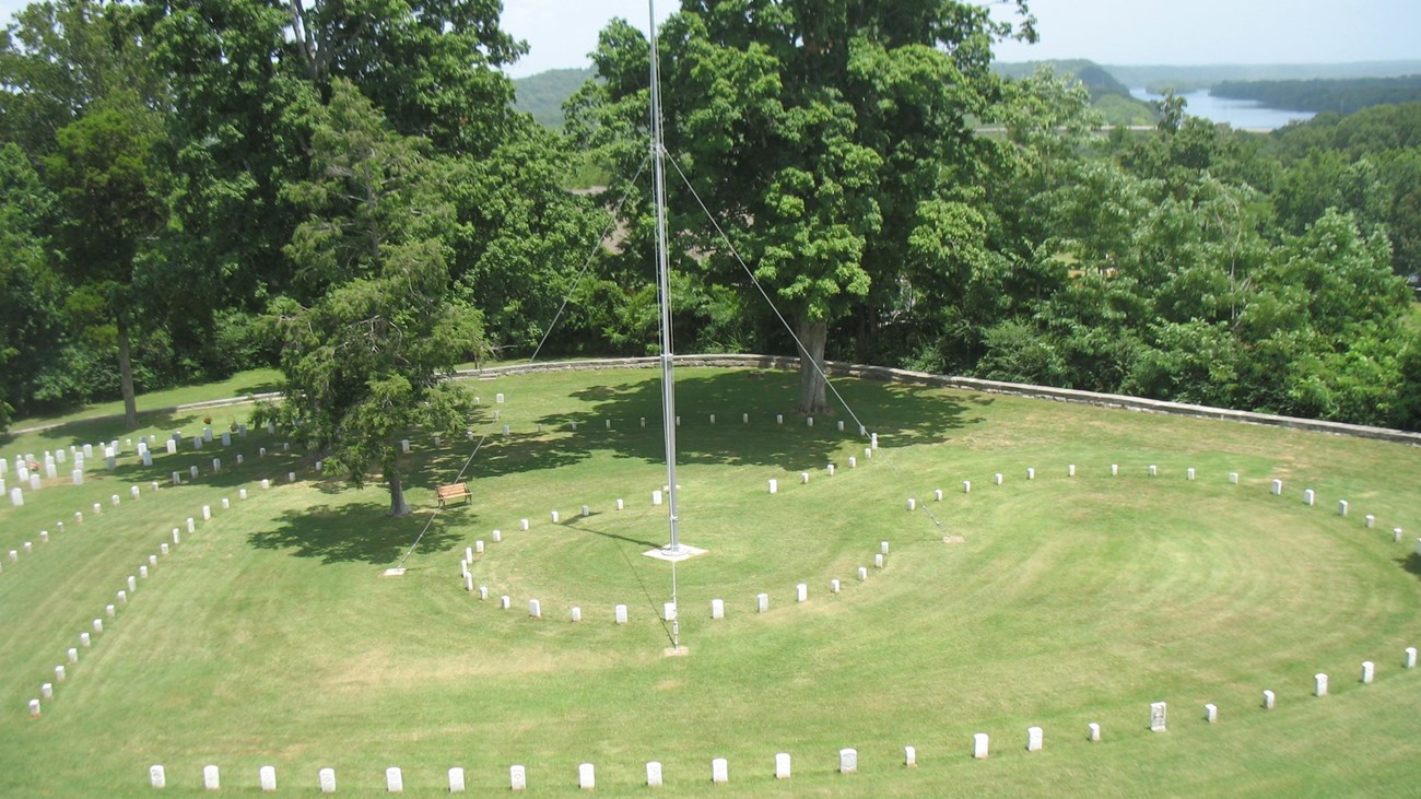 lawn with headstones and flagpole in cemetery