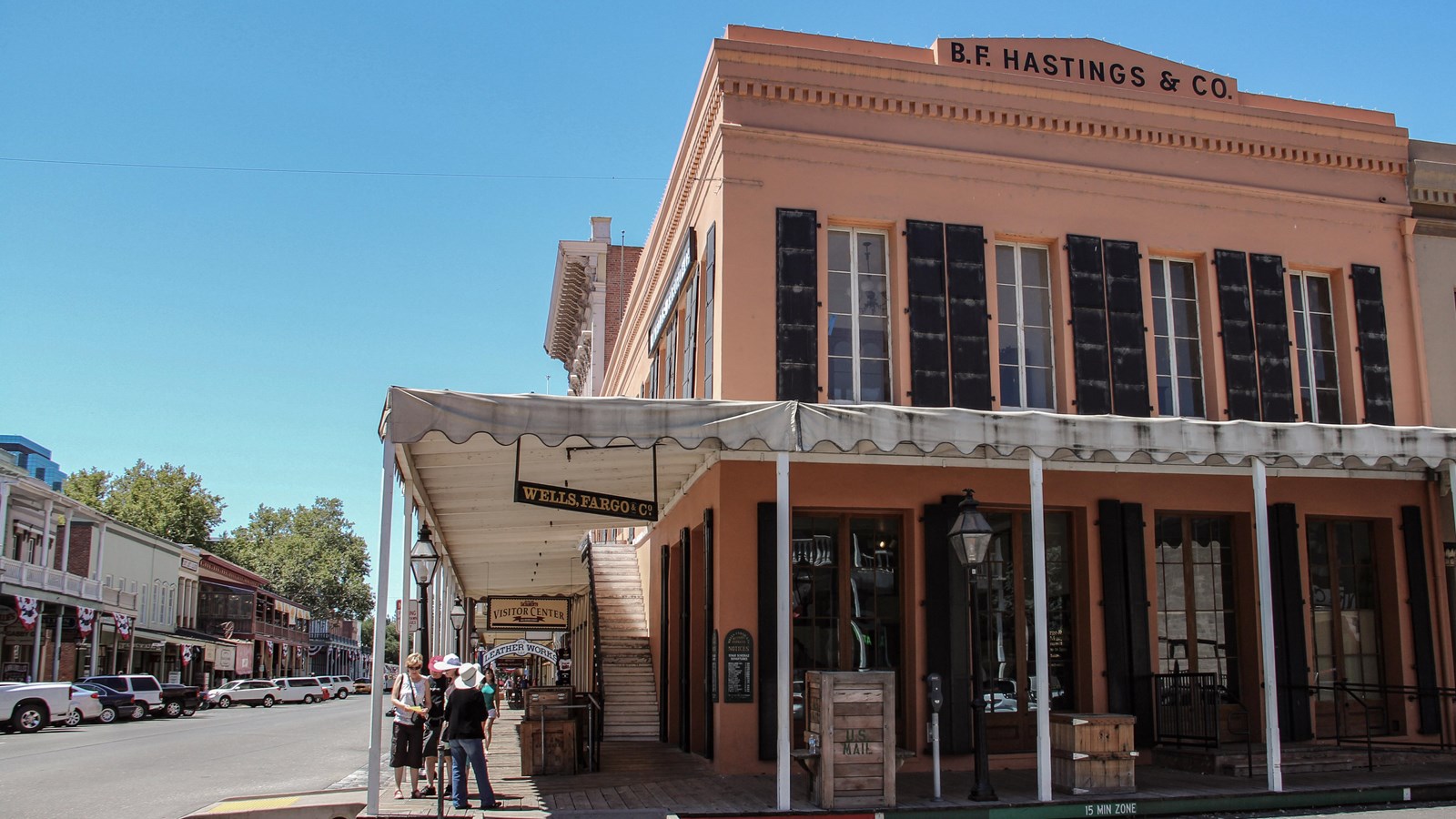 Large two story pink historic wooden building.