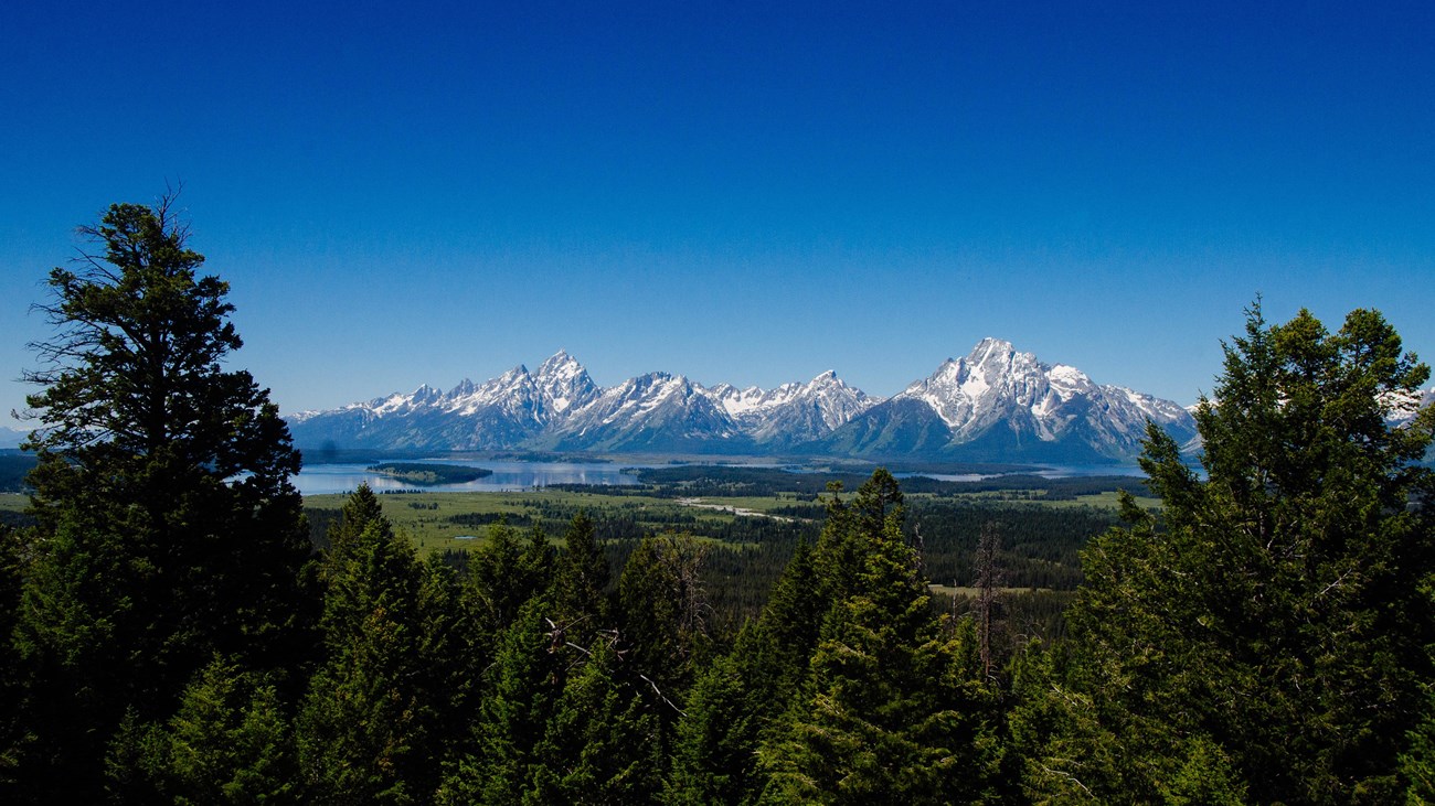 A mountain range and a lake as viewed from a high vantage point.