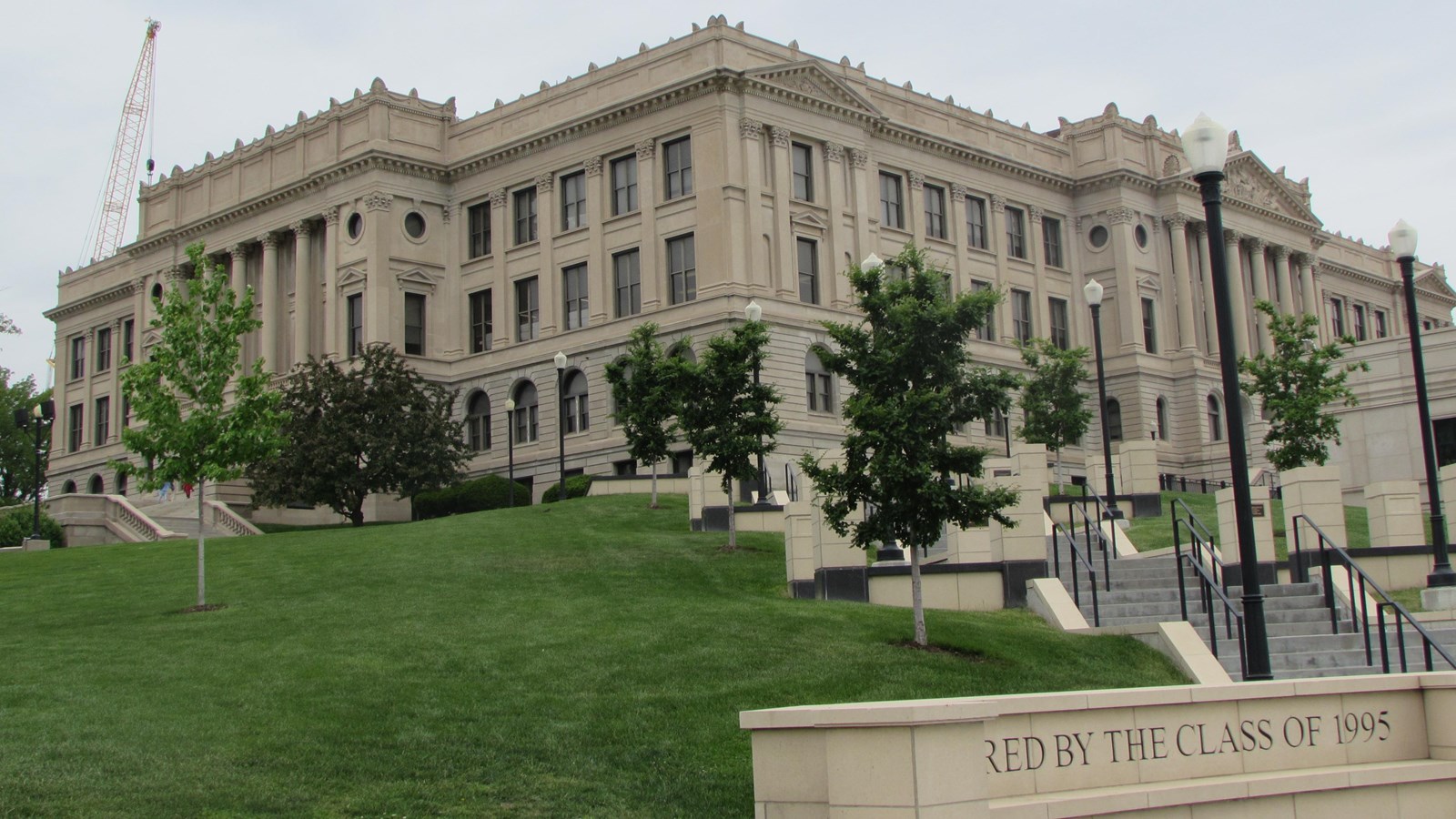 Large French Renaissance Revival style high school. Set on hill, shows two sides