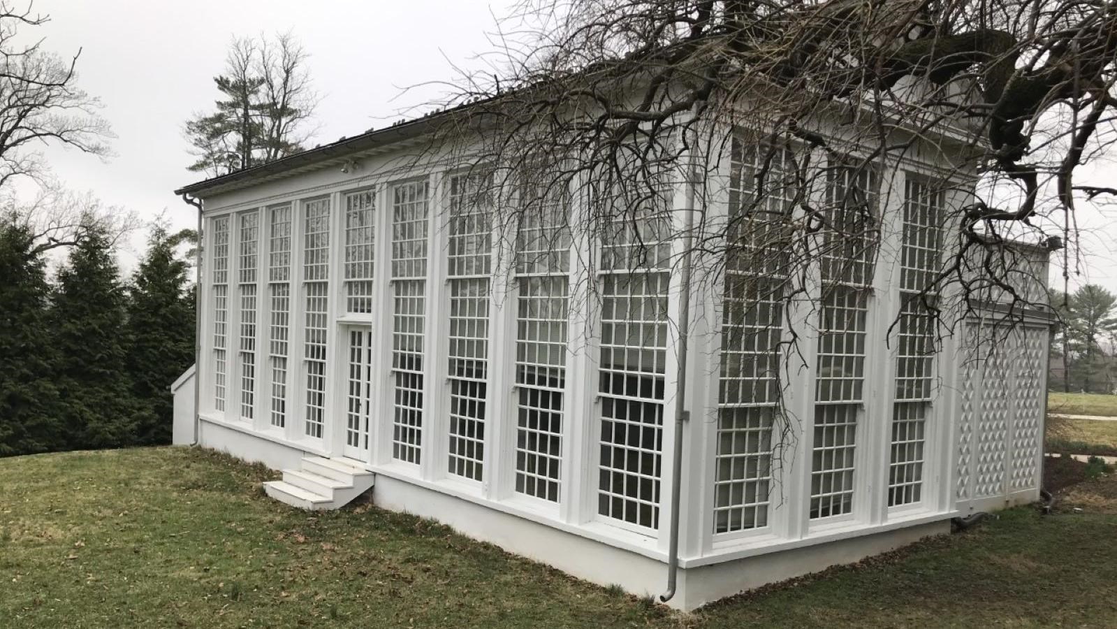A modern day image looking at the back of the orangery on a cloudy day.