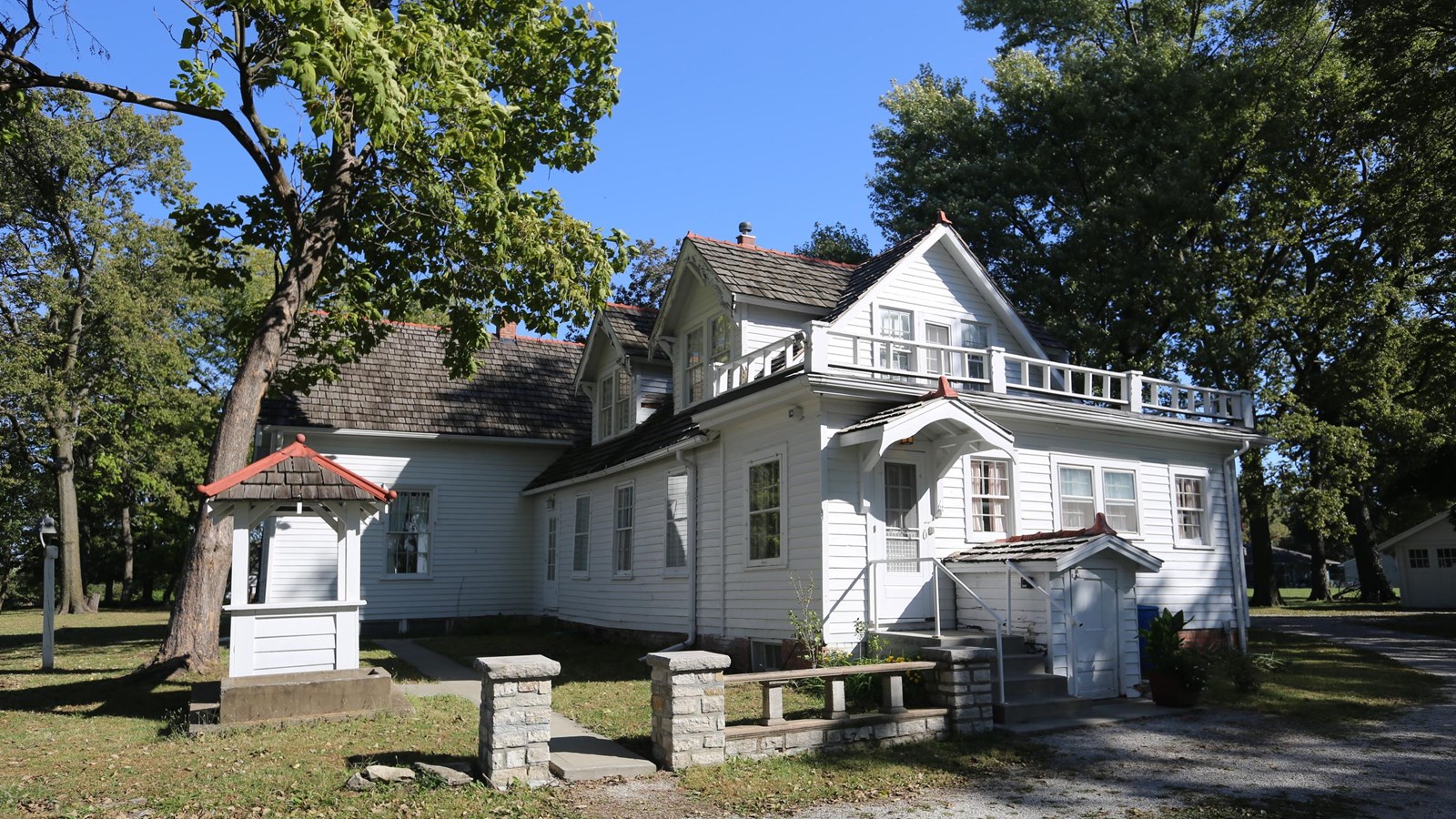 A large, white, gothic revival historic home.