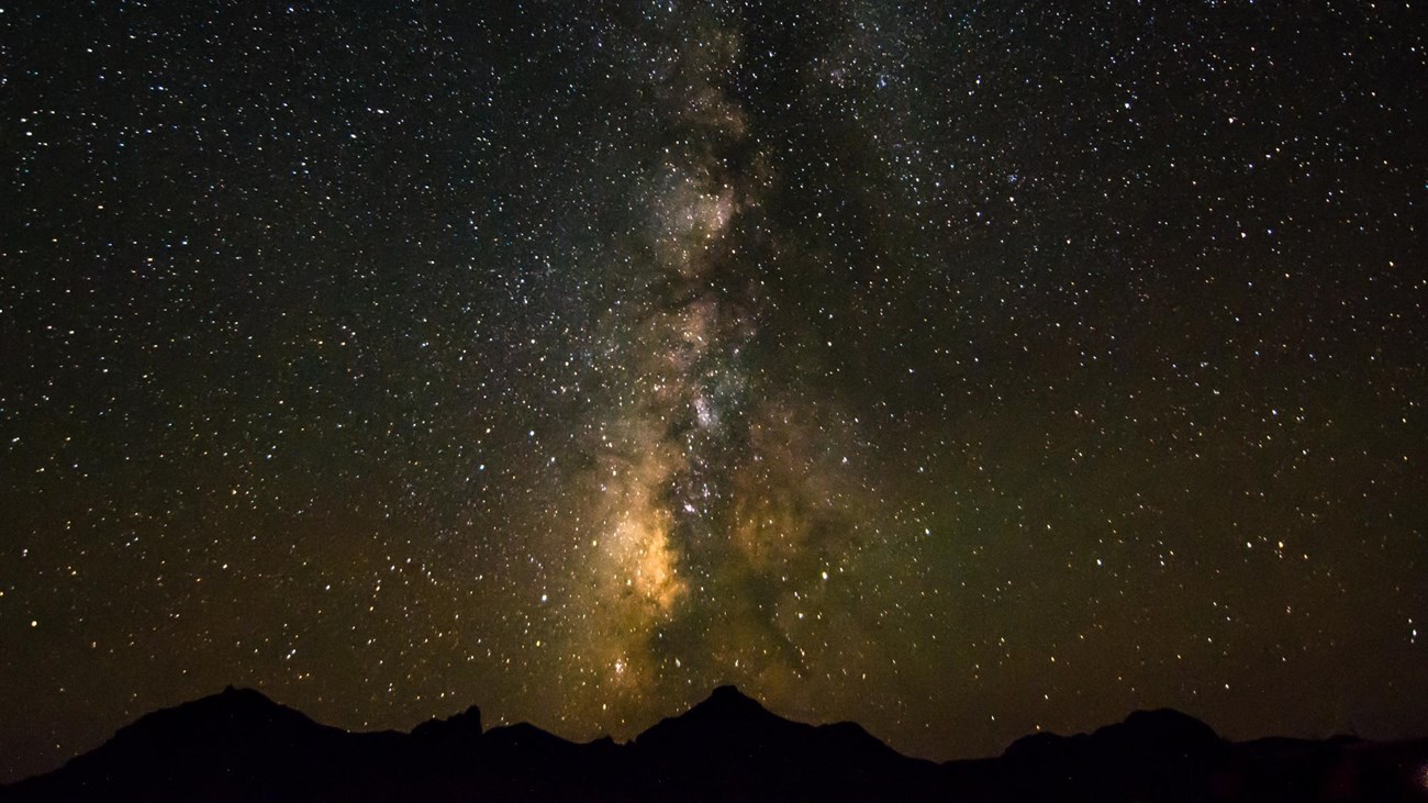 The Milky Way galaxy streaks across the sky.