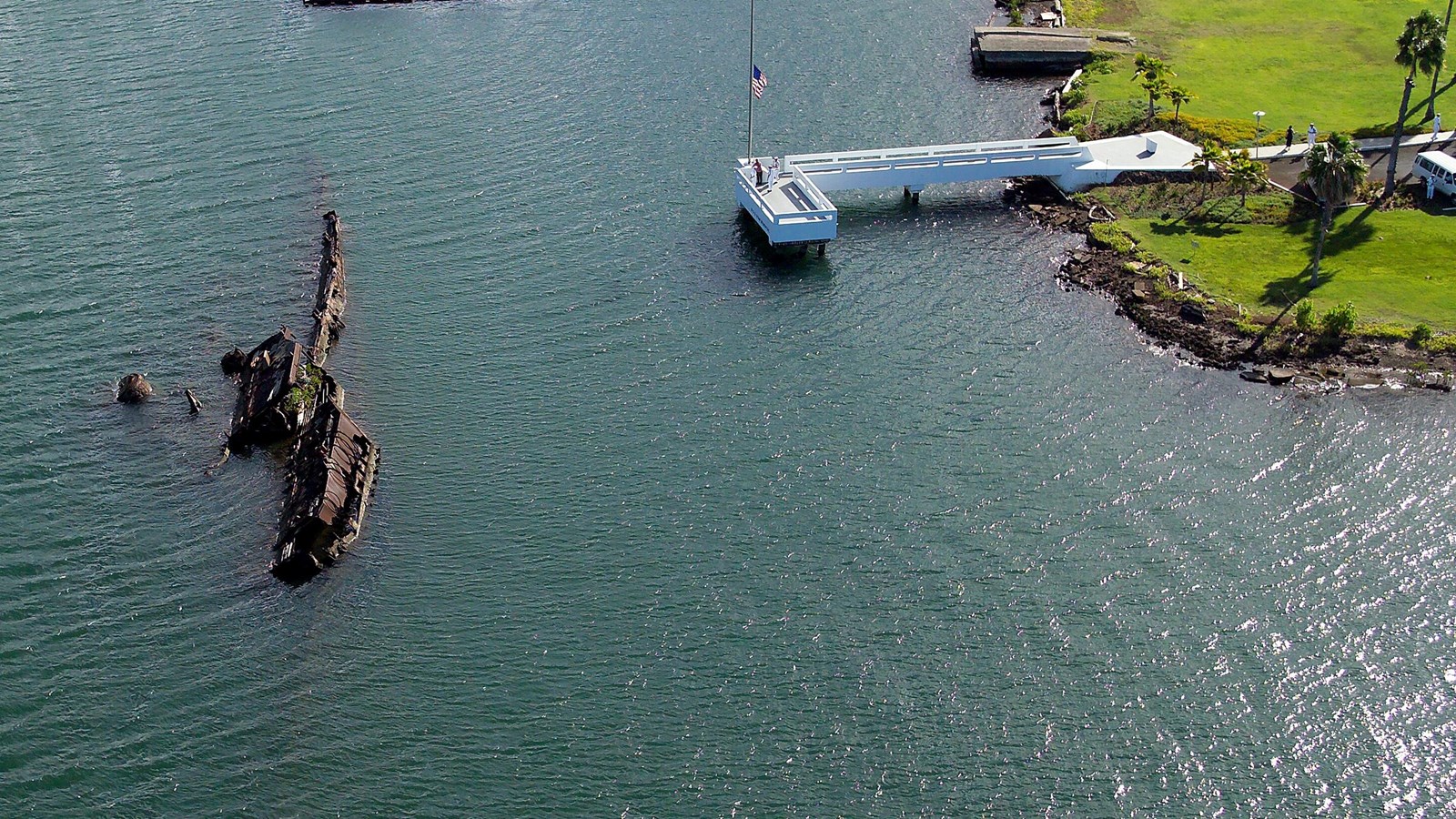A birds eye view of the USS Utah Memorial with the flag at half mast
