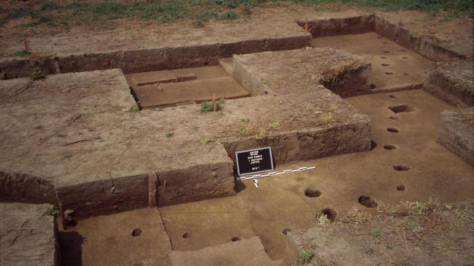 Excavation site with visible post holes.