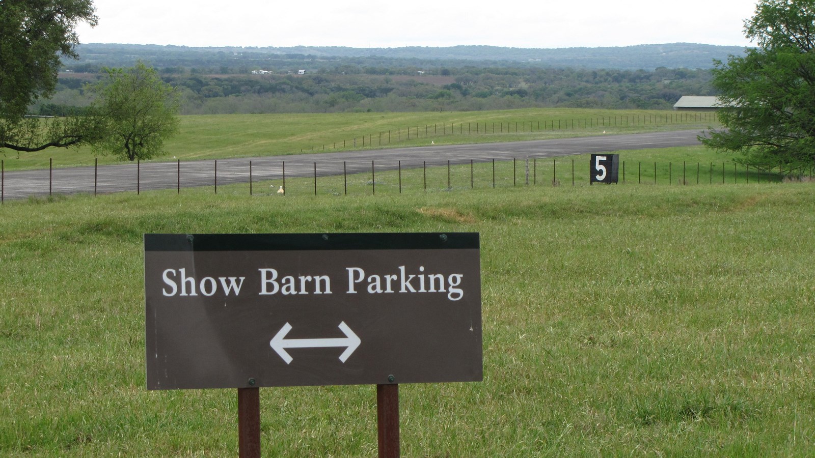 Beyond a brown sign with text 