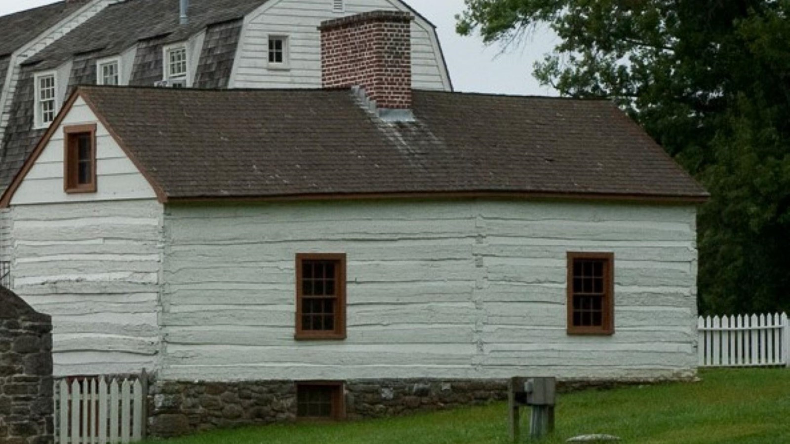 A modern day image of the rear of the log cabin building.