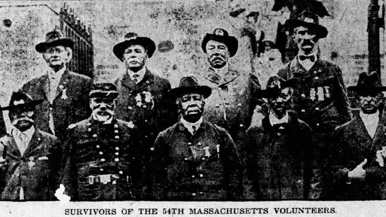 A group of African American Civil War veterans standing together in uniform.