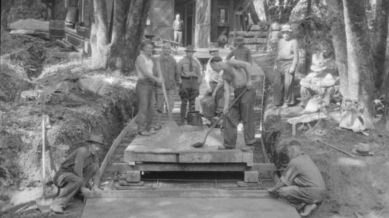 CCC members preparing a new driveway while being supervised by NPS staff.