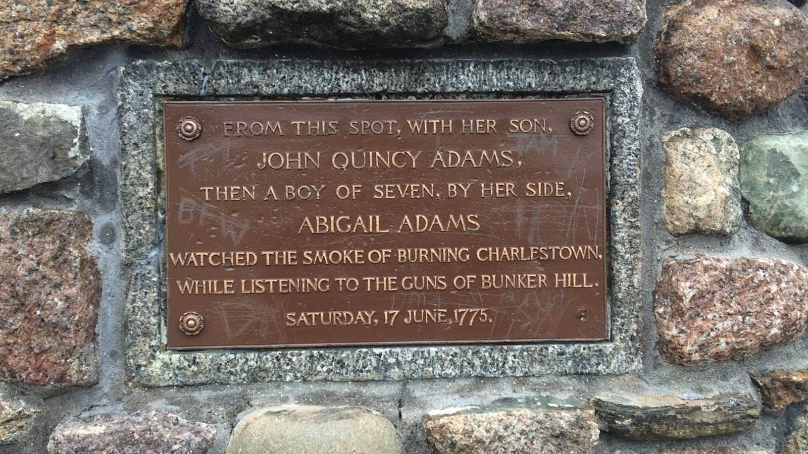 A plaque on the Abigail Adams Cairn detailing what it is.