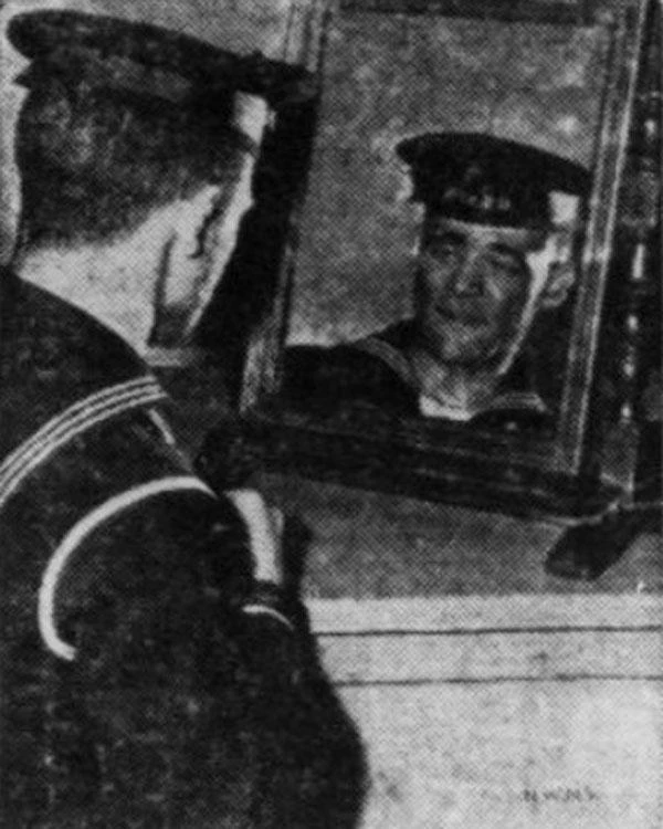 Portrait of George Fields in naval uniform looking in a mirror.
