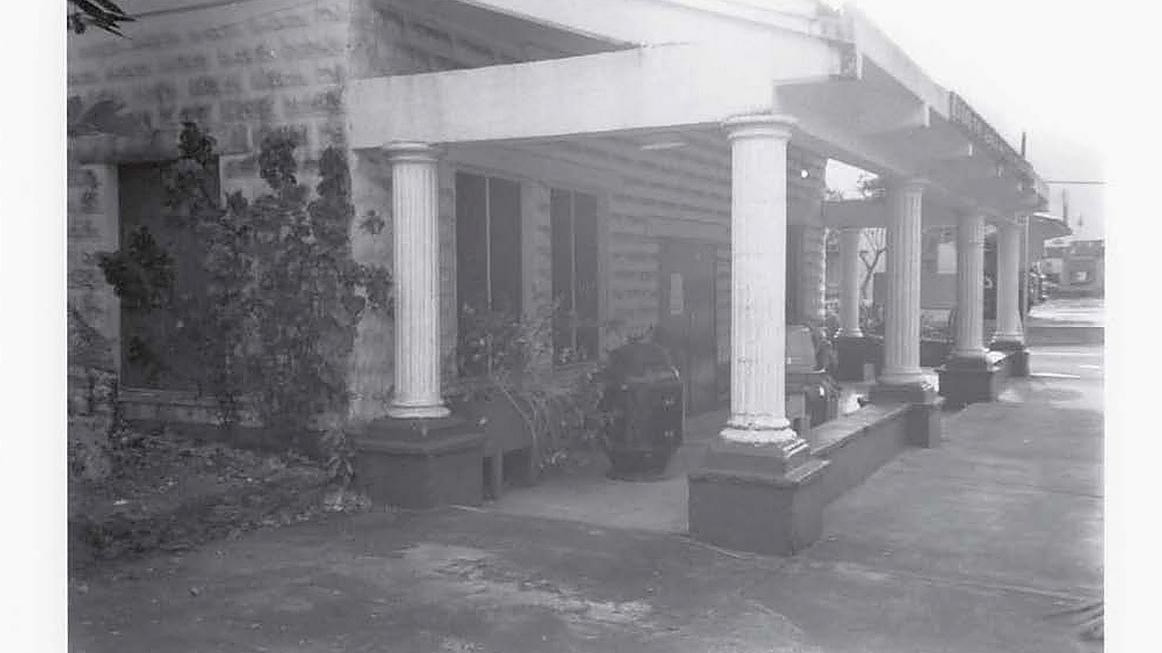 Black and white historical photo of a building with columns