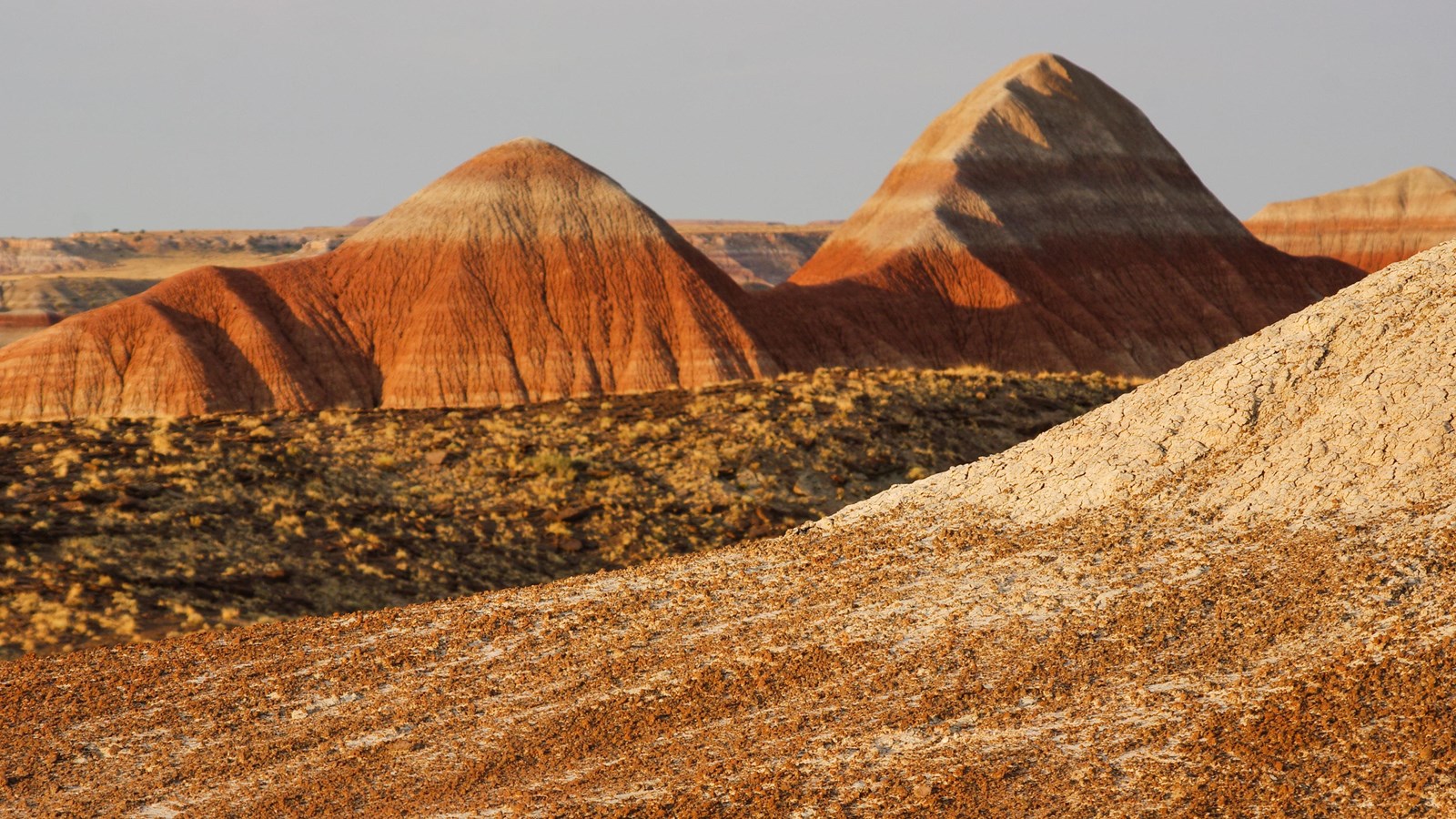 Red and gray badlands against a twilight sky