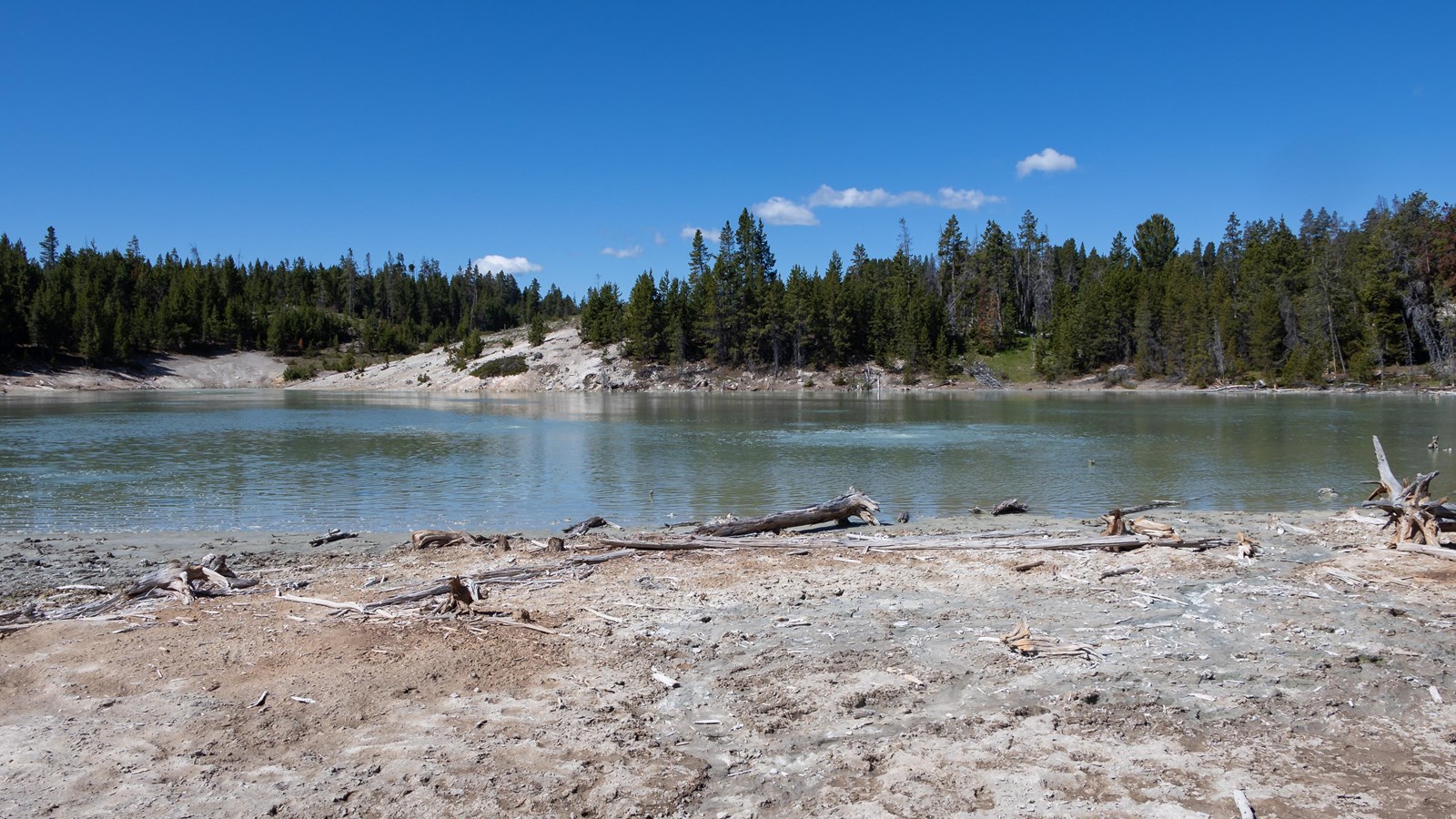 A turquoise lake located on the edge of a thermal basin.