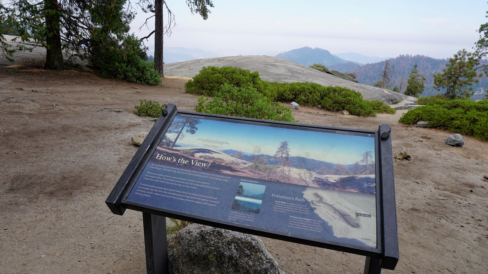 Outdoor exhibit with hazy mountains in the distance.