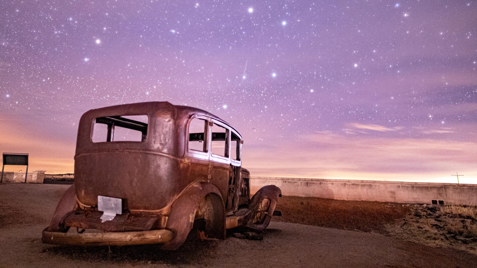 Old Studebaker under stars in a purple sky