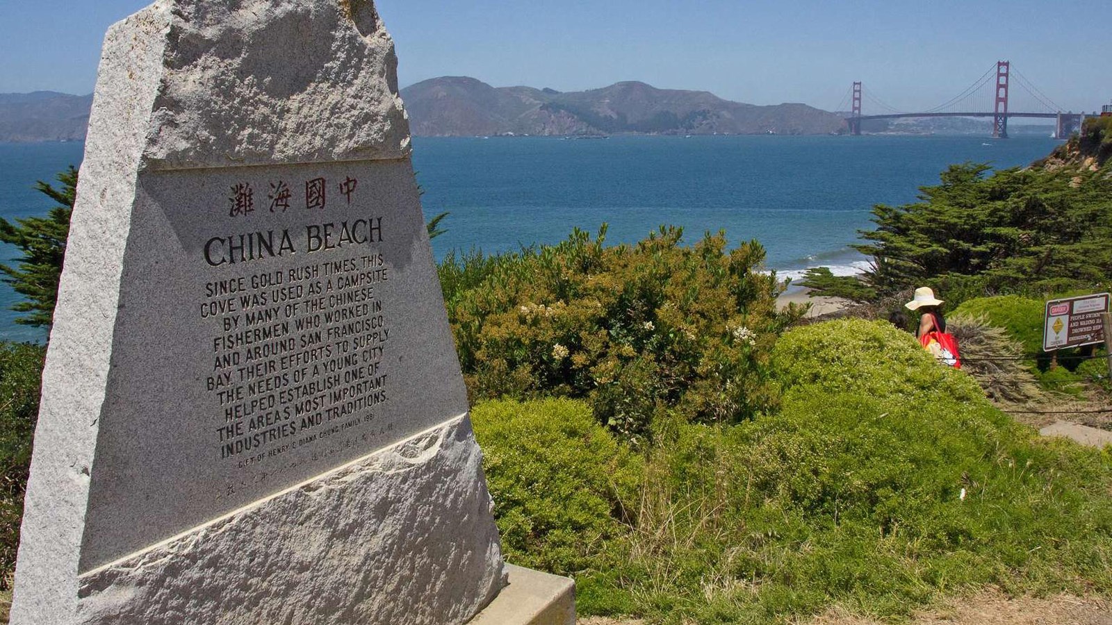 View of the China Beach Monument with the Golden Gate Bridge in the distance.