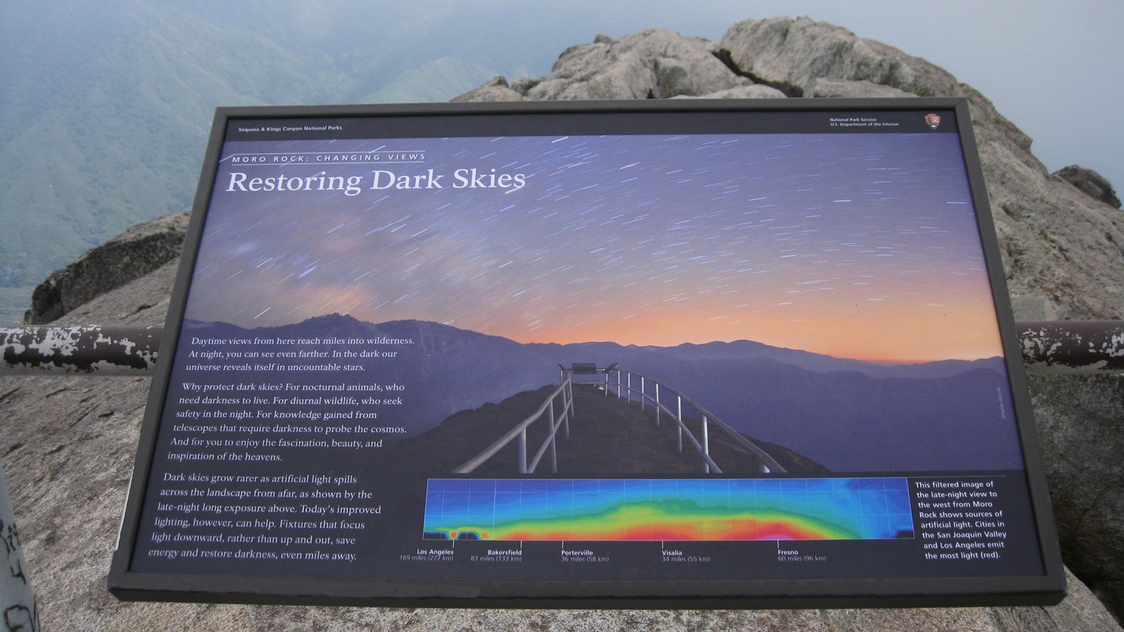 A sign titled Restoring Dark Skies features text and images about light pollution in the parks.